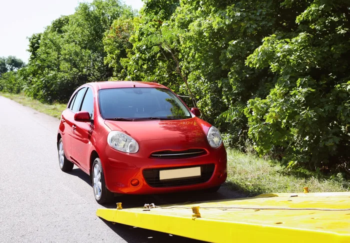 Unfallfahrzeug wird auf einen Abschleppwagen geladen